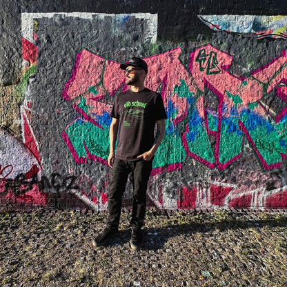 Person standing in front of a colorful graffiti wall
