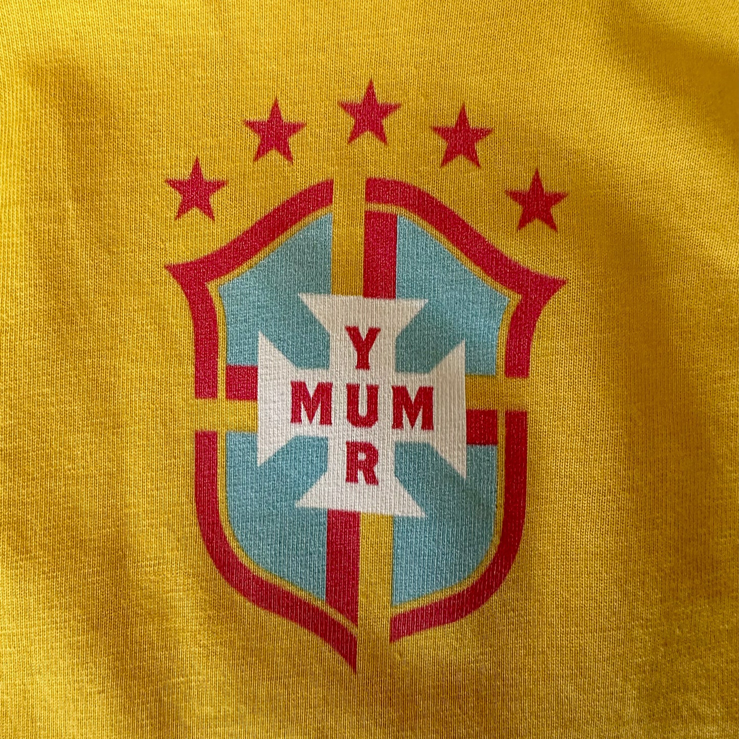 Football inspired emblem with 'Yur Mum' text on a yellow background